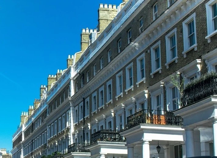 Row of Regency/Victorian-style terraced apartments with balconies, suitable for a managed residential block.